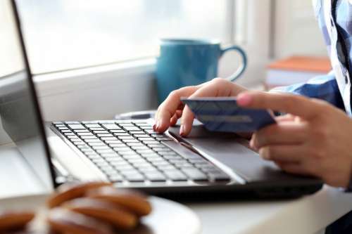 Girl with a laptop and credit card, online shopping