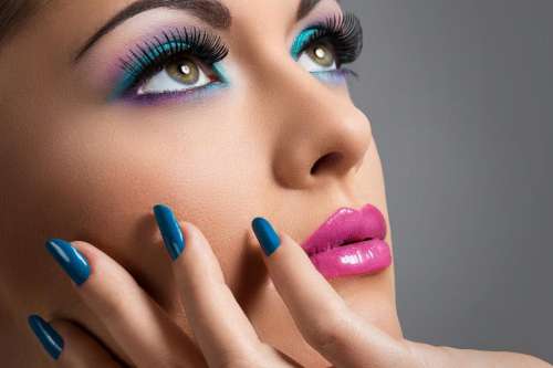Beautiful woman with colorful makeup, looking up