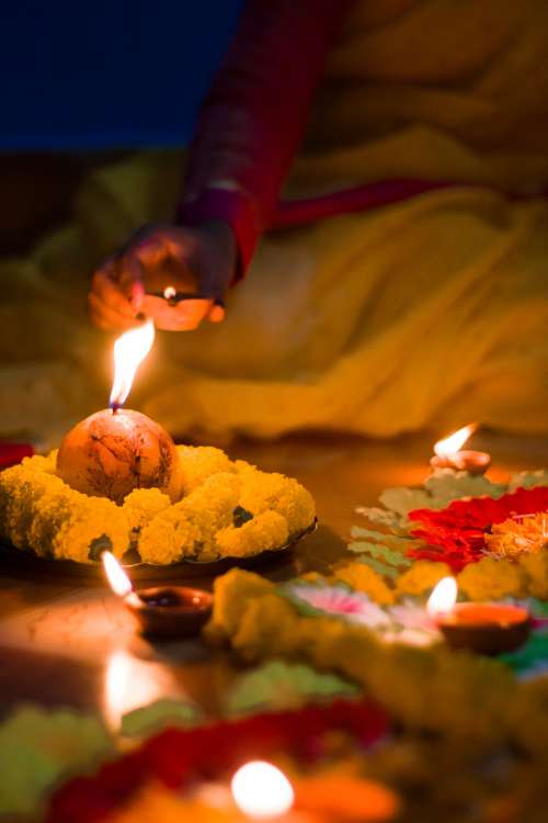 Lighting Colorful Candles For Diwali Photo