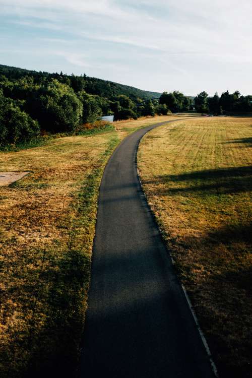 Paved Road Through A Open Field Photo