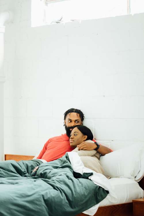 Couple Cozy Up In Bed Photo
