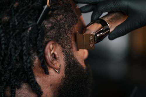 Close Up Of Barber Cutting Hair With Clippers Photo