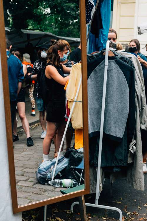 Mirror Reflects Shoppers With Face Mask Photo