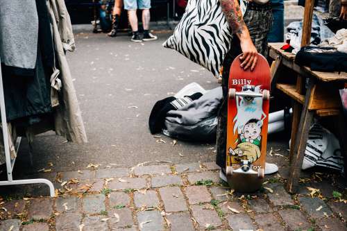 Skateboarder Shops In An Outdoor Market Photo
