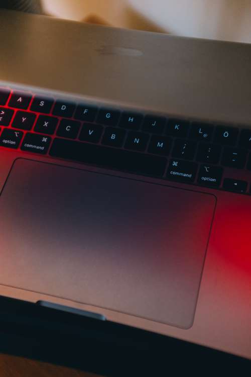 Partially Closed Laptop In Red Light Photo
