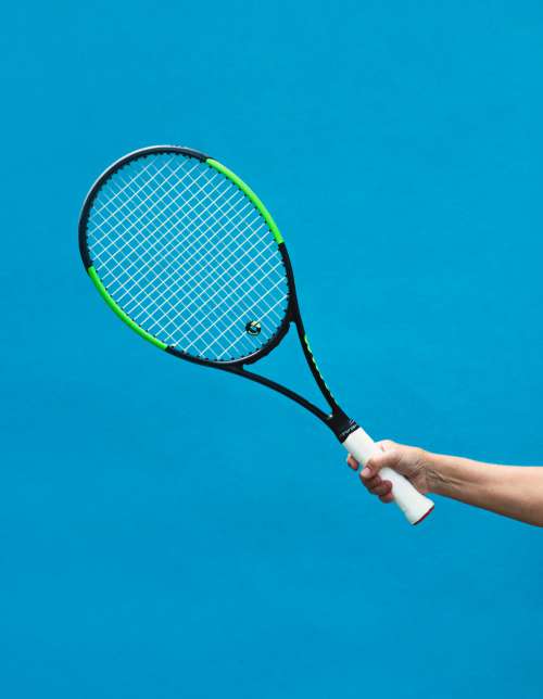 A Black And Green Tennis Racket Photo