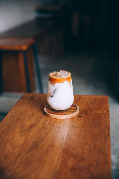 Creamy Cold Drink Sits On A Wooden Table Photo