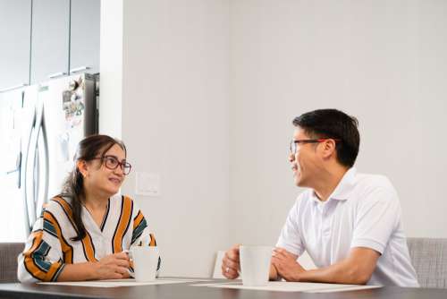 Two People Have Tea At The Kitchen Table Photo