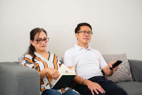 Two People Read And Watch Television Photo