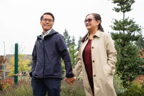 Couple Holds Hands And Walks Though A Empty Park Photo