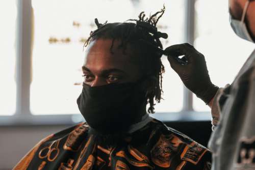 Man With Face Mask In Barbershop Photo