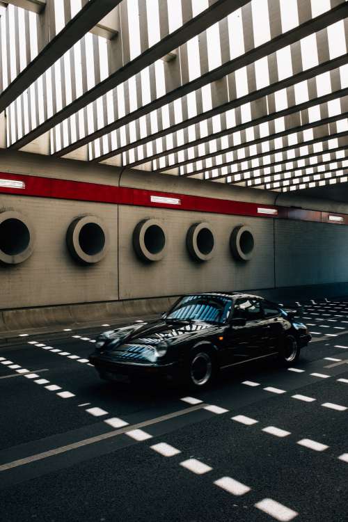 Classic Car Races Through Modeern Tunnel Photo