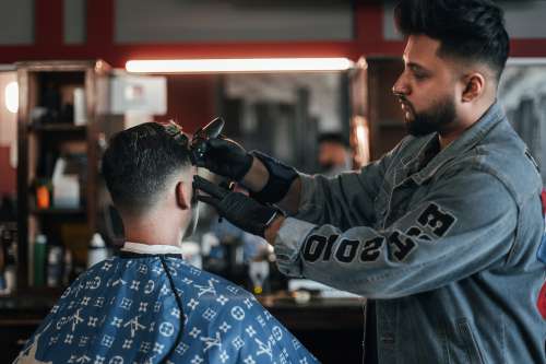 Customer Getting Fade At Barbershop Photo