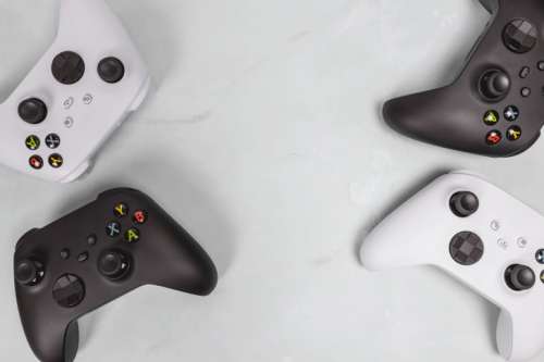 Gaming concept. White and black joysticks on white background.