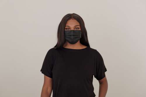 Woman Wearing A Black Dispoable Face Mask Photo