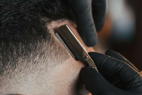 Close Up Of A Straight Razor In Use Photo