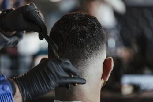 Barber Adds Final Touches To A Haircut Photo