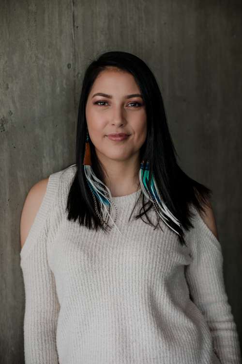 Woman In White Sweater Looks Into Camera Lens Photo