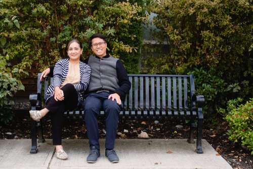 Man And Woman Together Smile On Park Bench Photo