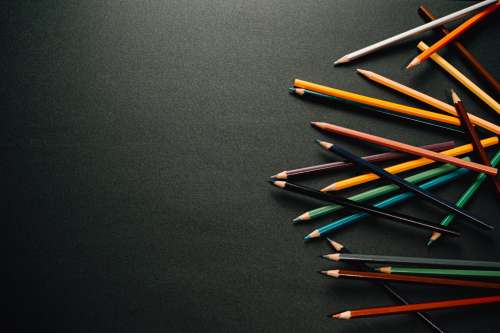 Colorful Pencil Crayons On Black Background Photo