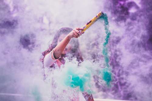 A Person Surrounded By Purple And Blue Smoke Photo
