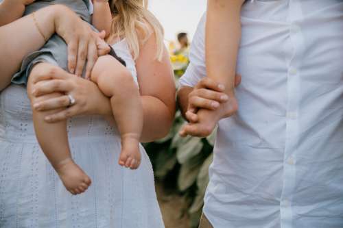 Kids Feet Held By Adults Photo