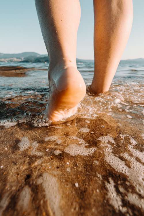 Feet Walk Into The Water Photo