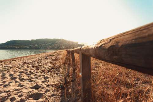 Wooden Fence On Sandy Beach Photo