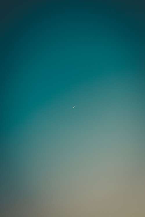 Small Crescent Moon In Blue Sky Photo