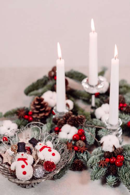 Christmas spruce decoration with candles and snowmen