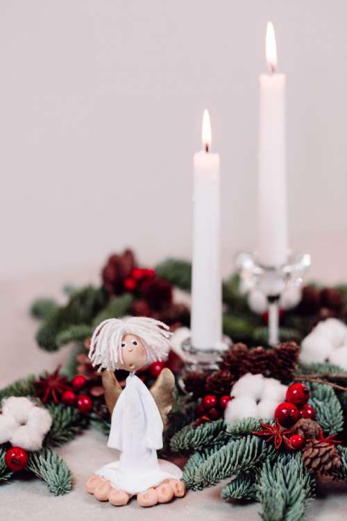 Christmas spruce decoration with candles and an angel