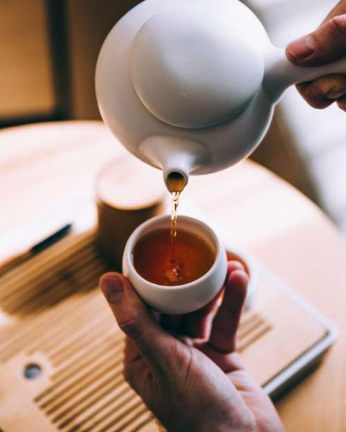 Hands Pouring Tea