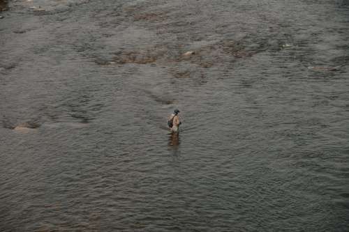 Birds Eye View Of A Fisherman Standing In The River Photo