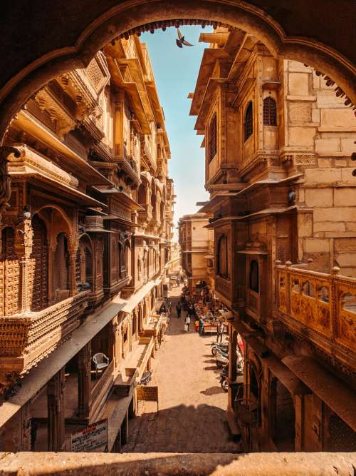 Beautiful City Street With Stone Building And Carved Balconies Photo