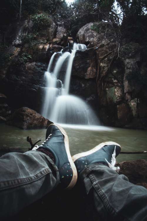 View Of A Waterfall From The Lap Of The Photographer Photo