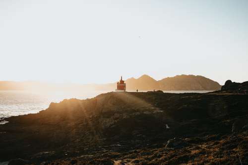 Lighthouse Peaks At Sunset Photo
