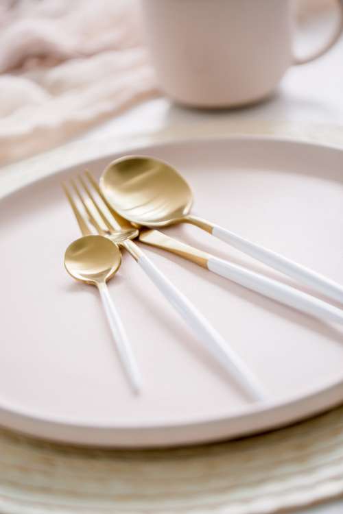 Gold And White Cutlery On Plate Photo