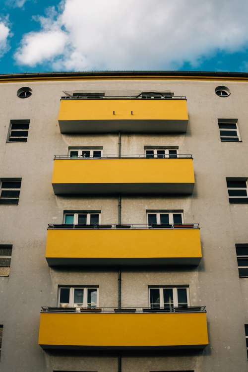 Apartment Building With Yellow Balconies Photo
