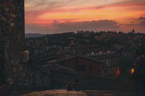 Two People On A Roof Together Taking In The Sunset Photo