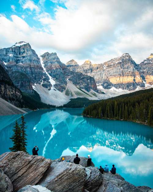 Snowy Mountains Reflect In A Blue Pond Photo