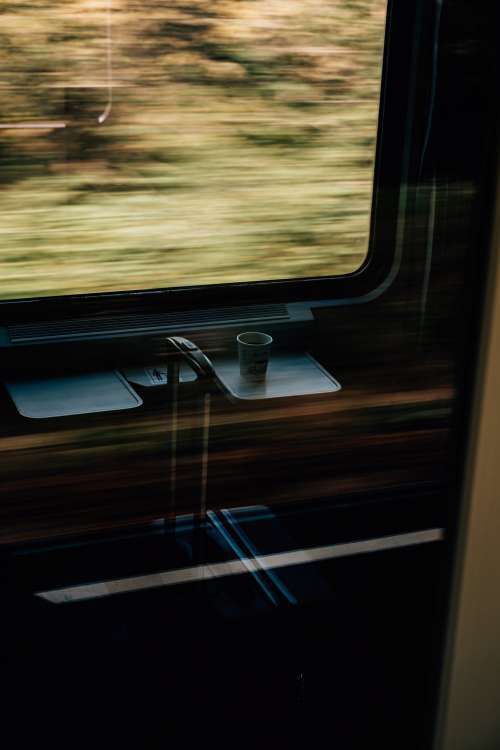 White Paper Cup And Suitcase On A Fast Moving Train Photo