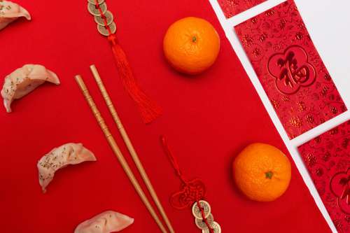 Flatlay With Dumplings And Chopsticks Against A Red Background Photo