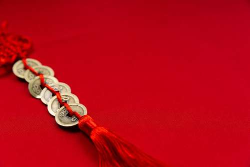 Gold Coins Weaved Onto Red Rope Photo