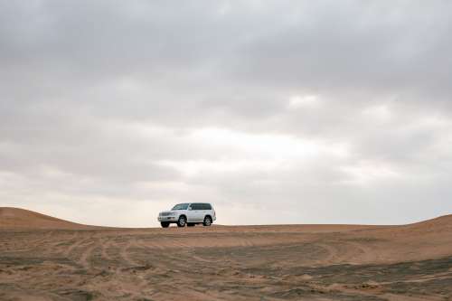 White Car In The Red Desert Sand Photo