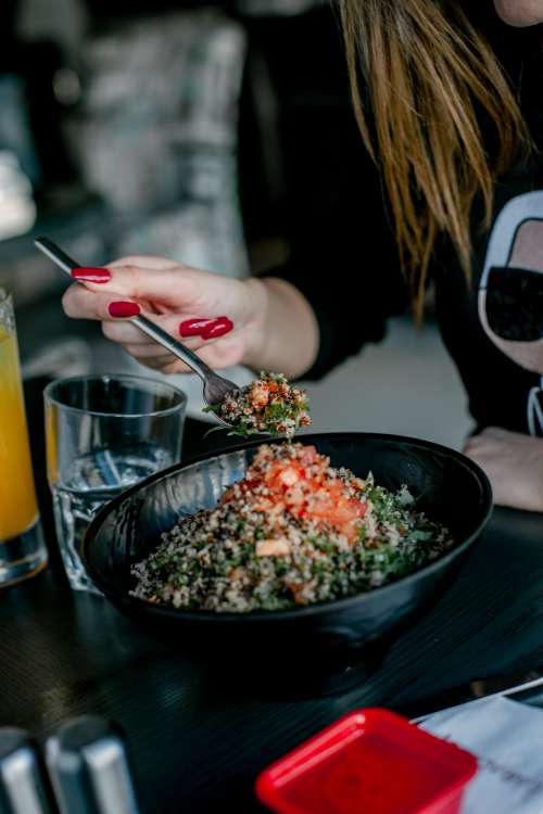 Person Enjoys A Quinoa Salad Photo