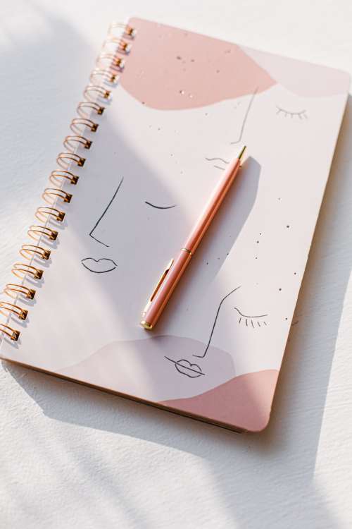 Pink Notebook And Pink Pen Photo
