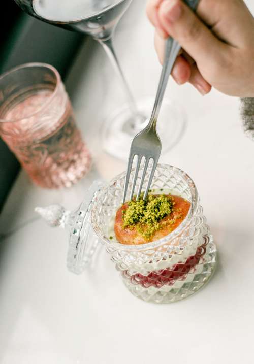 Fork Dips Into A Dessert In A Crystal Container Photo