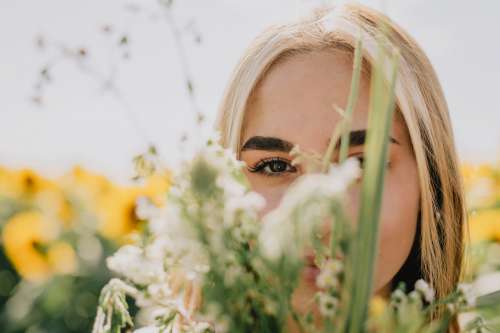 Close Up Of Person With Brown Eyes Looking Through Foliage Photo