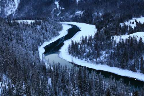 Cold Winding River In A Snow Covered Forest Photo
