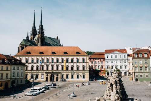 Town Square With Church Roof Peaking Over The Building Photo